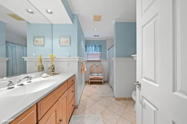 a en suite bathroom with a double vanity sink a mirror and a