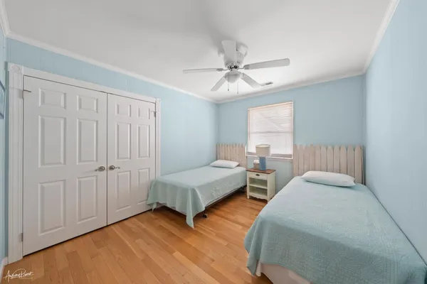 a bedroom with two beds and a chandelier