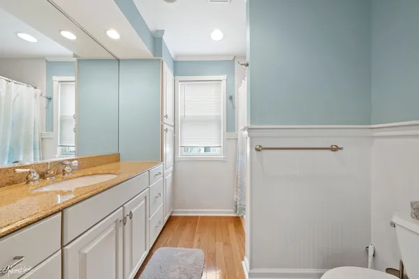 a bathroom with a sink a toilet a shower and a mirror