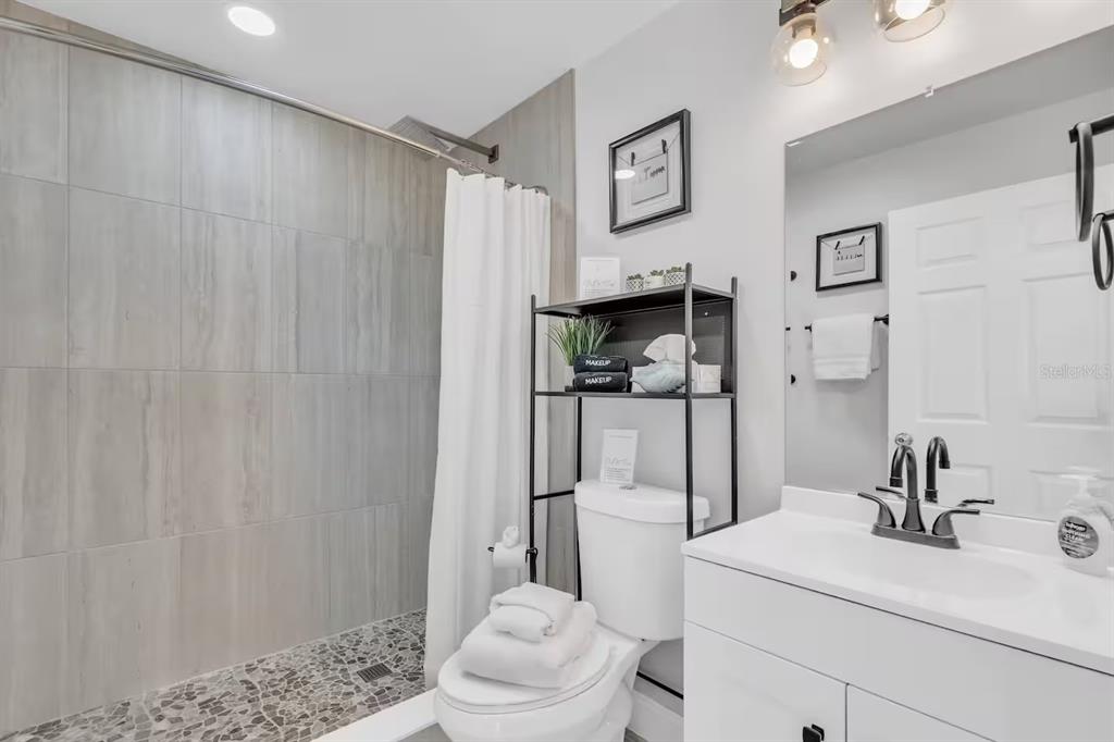 1317 13th Street, Unit B Sarasota, FL 34236 - Photo 18 of 36 a bathroom with a sink toilet and shower