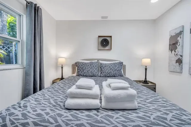 a bedroom with a bed and a window