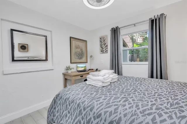 a view of a chair and table in backyard of the house