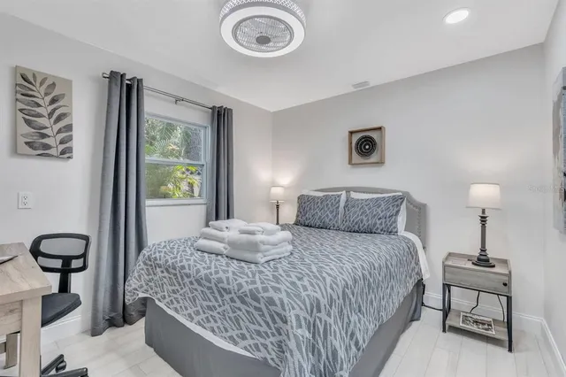 a bedroom with a bed and a chandelier