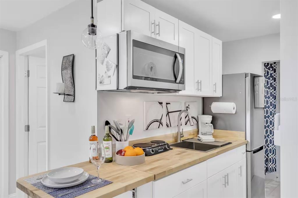 1317 13th Street, Unit B Sarasota, FL 34236 - Photo 23 of 36 a kitchen with stainless steel appliances granite countertop a sink a stove and refrigerator