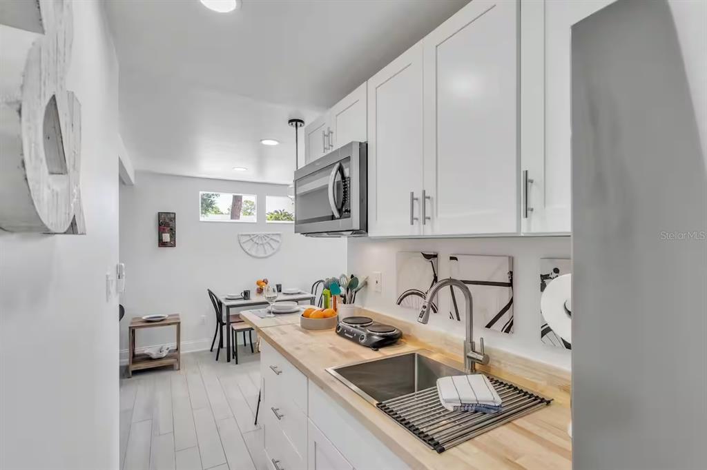 1317 13th Street, Unit B Sarasota, FL 34236 - Photo 30 of 36 a kitchen with stainless steel appliances granite countertop a sink stove and cabinets