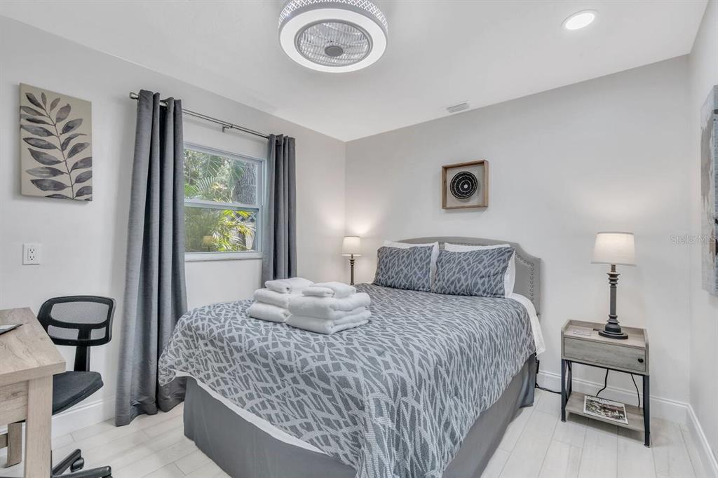 1317 Cocoanut Avenue, Unit B Sarasota, FL 34236 - Photo 3 of 36 a bedroom with a bed and a chandelier