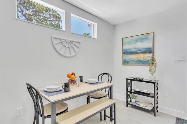 a backyard of a house with a table and chairs