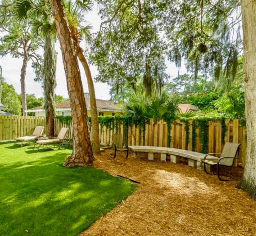 1317 13th Street, Unit B Sarasota, FL 34236 - Photo 35 of 36 a backyard of a house with a table and chairs