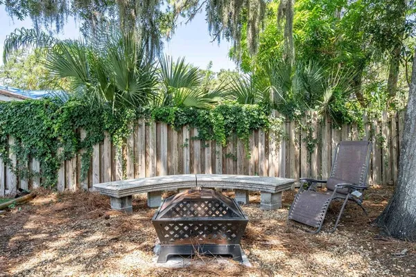 a view of a chair and table in a backyard