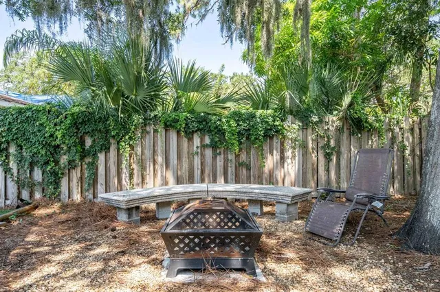 a view of a chair and table in a backyard