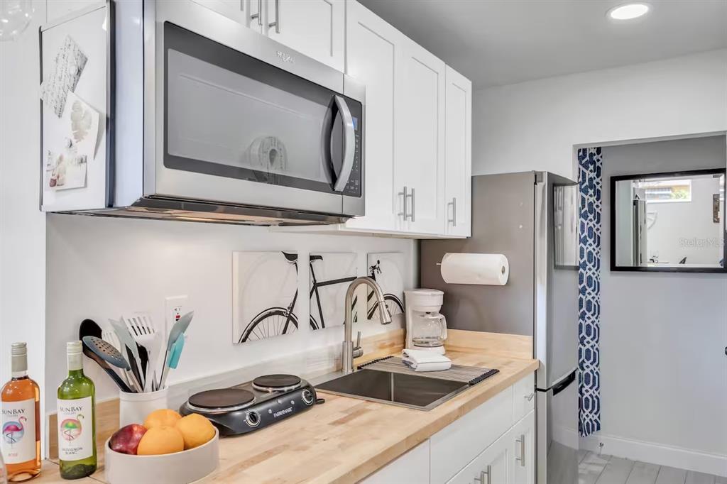 1317 13th Street, Unit B Sarasota, FL 34236 - Photo 5 of 36 a kitchen with a stove and a microwave