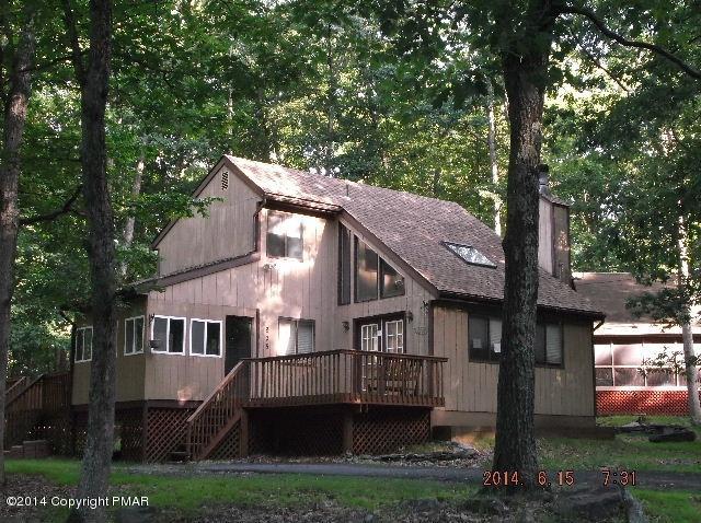 935 Decker Road Bushkill, PA 18324 - Photo 1 of 15 a view of a white house next to a yard with big trees