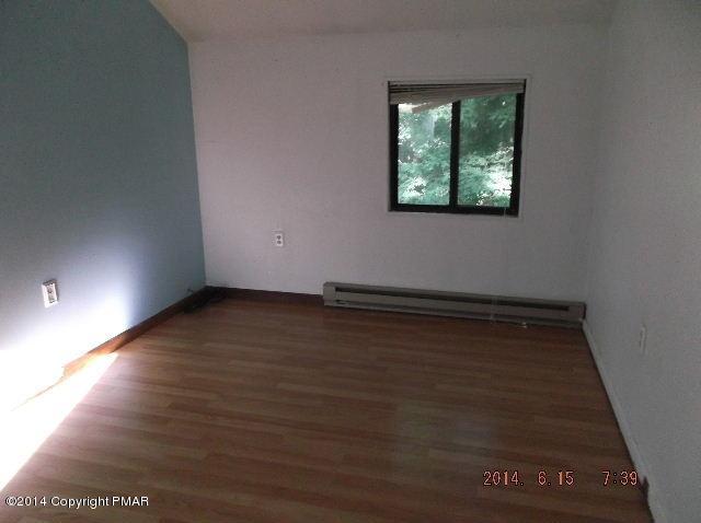 935 Decker Road Bushkill, PA 18324 - Photo 11 of 15 an empty room with wooden floor and windows