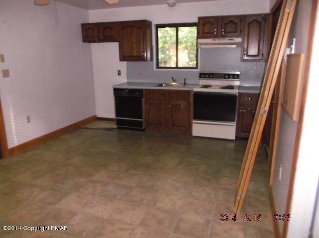 935 Decker Road Bushkill, PA 18324 - Photo 5 of 15 a kitchen with stainless steel appliances granite countertop a stove a sink and a refrigerator