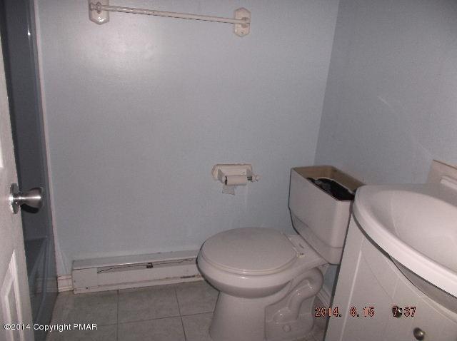 935 Decker Road Bushkill, PA 18324 - Photo 7 of 15 a white toilet sitting next to a white sink and vanity