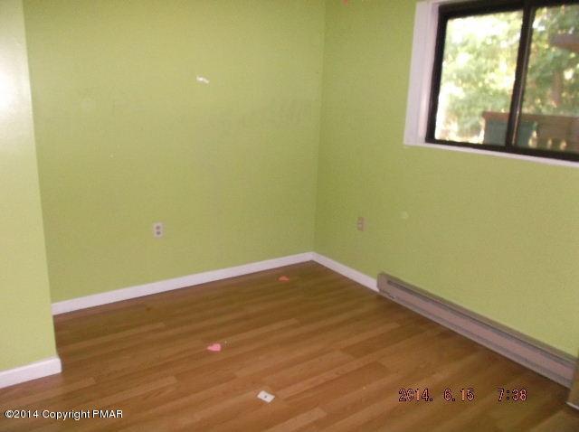 935 Decker Road Bushkill, PA 18324 - Photo 9 of 15 a view of a small space with wooden floor and a window