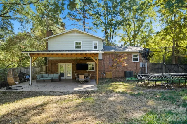 a view of a house with backyard porch and sitting area