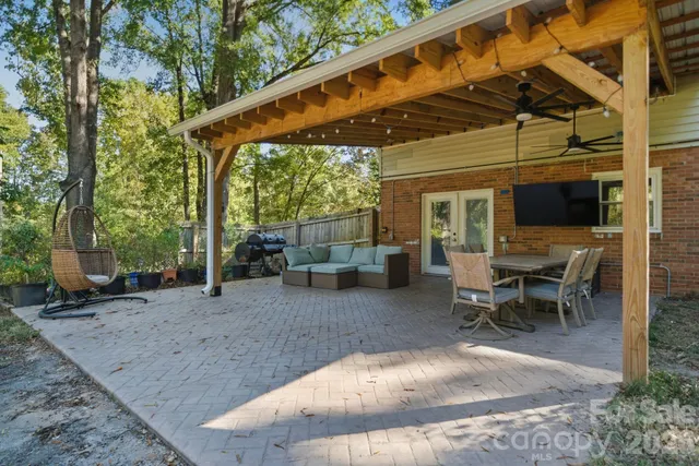 a view of a backyard with sitting area and furniture