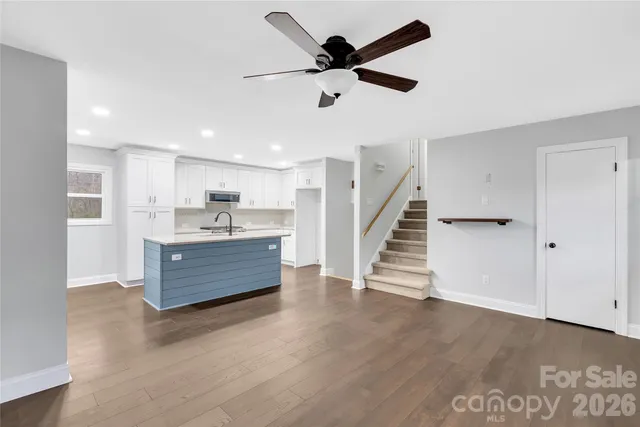 a view of kitchen with cabinets and wooden floor