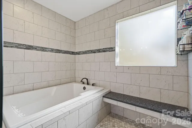a bathroom with a tub and a shower
