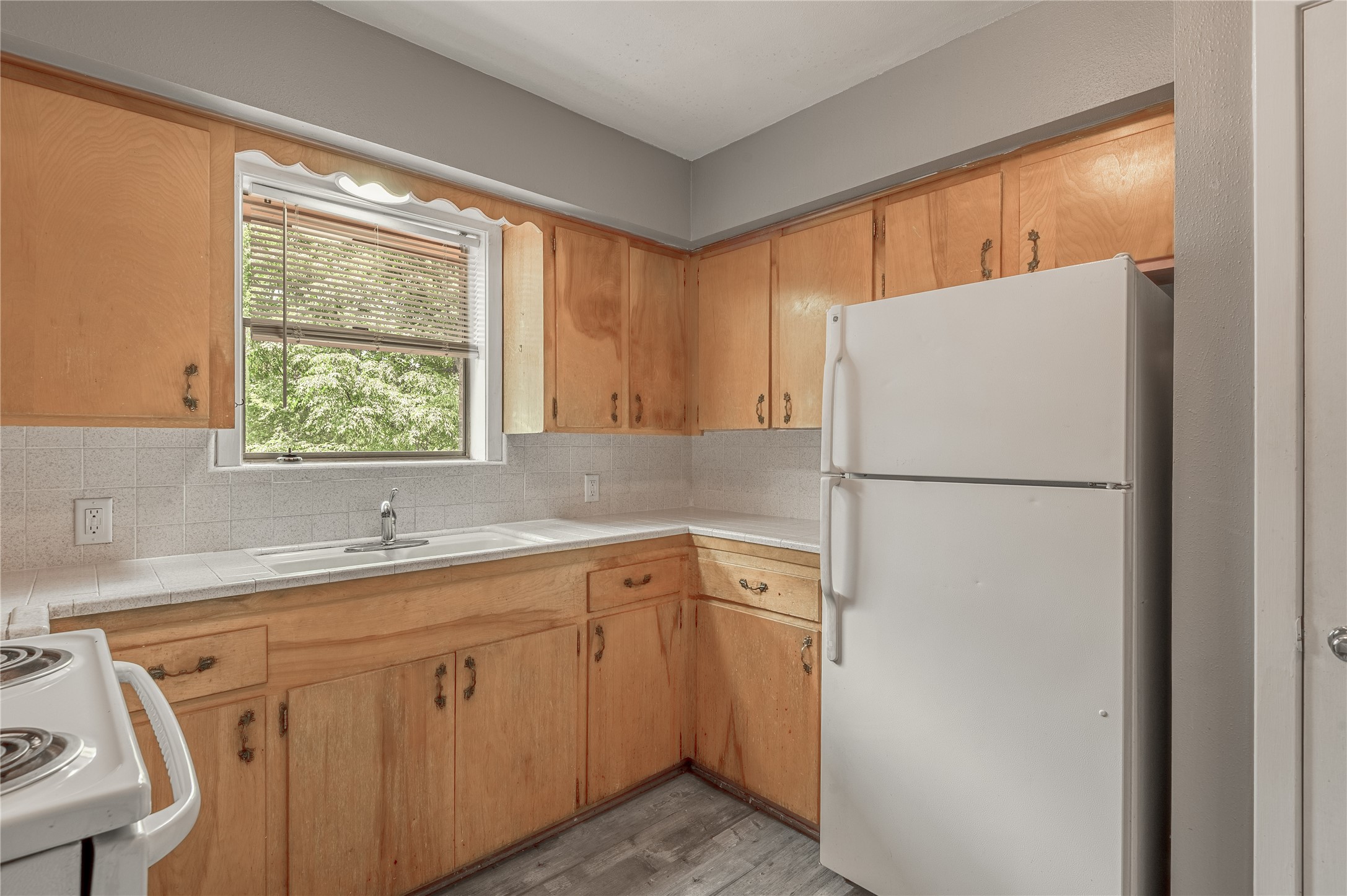818 University Avenue, Unit 7 Huntsville, TX 77320 - Photo 13 of 25 a white refrigerator freezer sitting inside of a kitchen