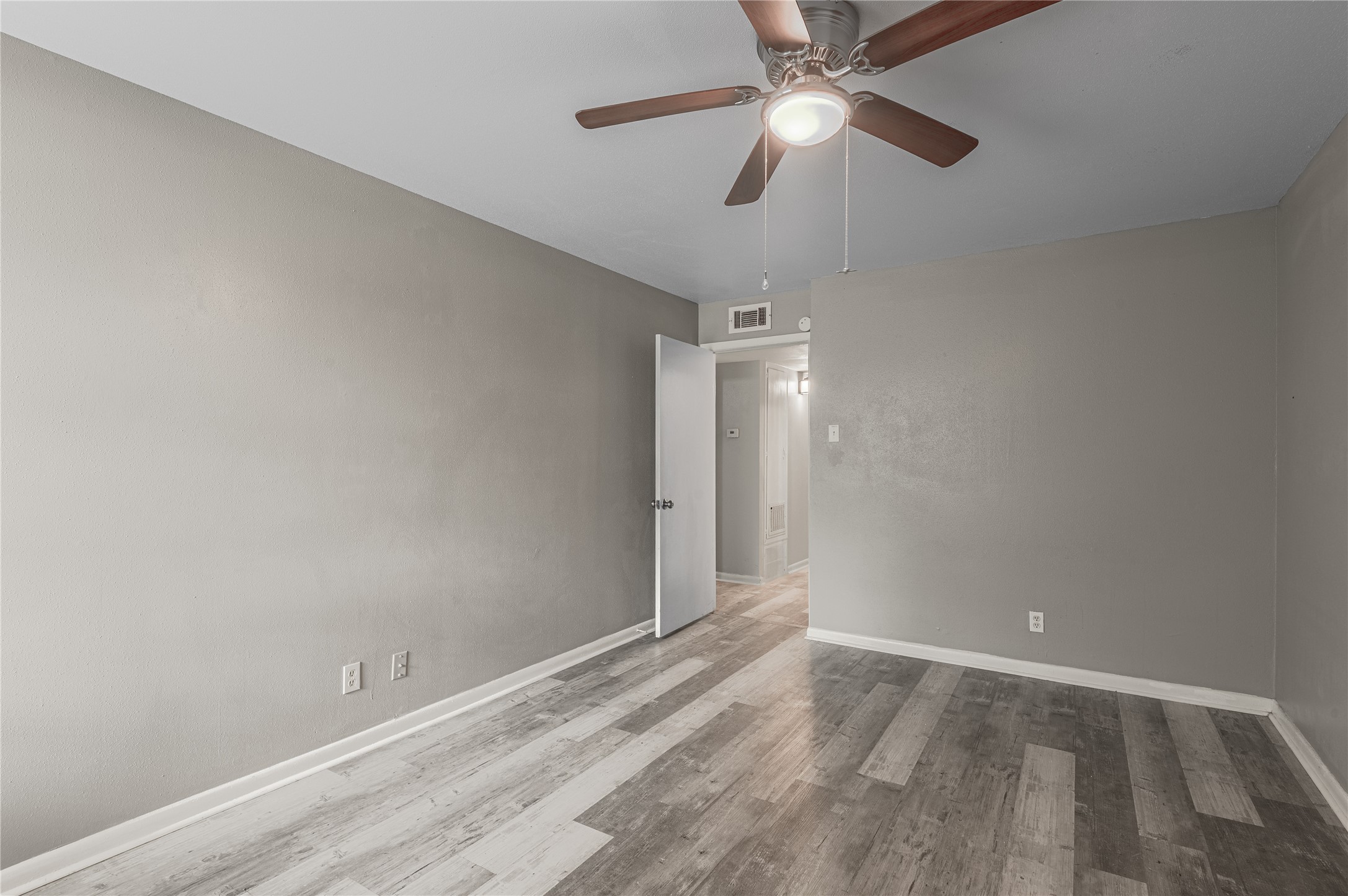 818 University Avenue, Unit 7 Huntsville, TX 77320 - Photo 17 of 25 wooden floor in an empty room
