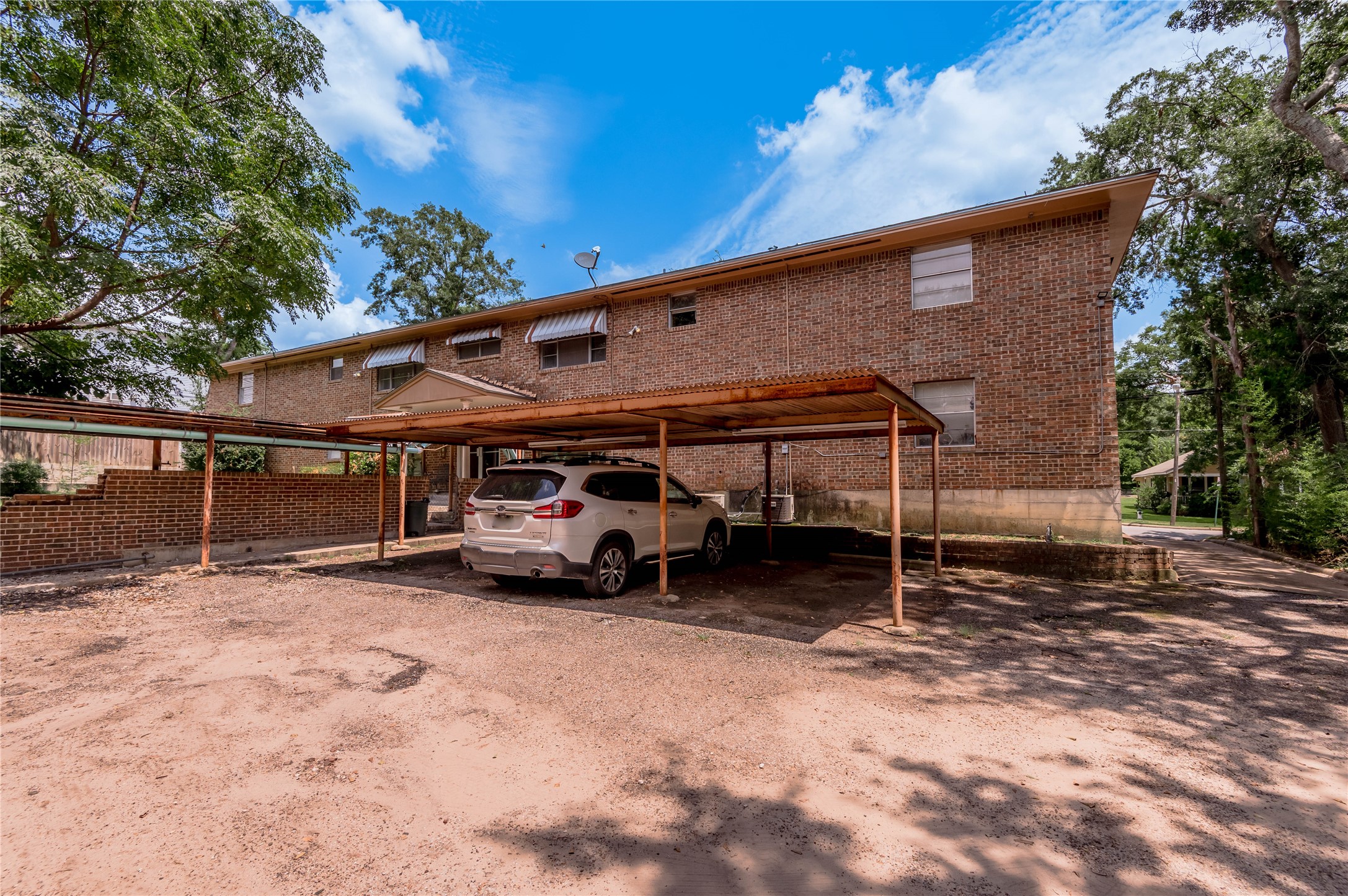 818 University Avenue, Unit 7 Huntsville, TX 77320 - Photo 23 of 25 a view of a house with a yard and garage