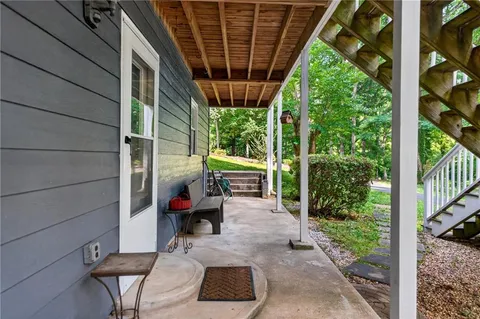 a view of a roof deck with wooden fence and floor
