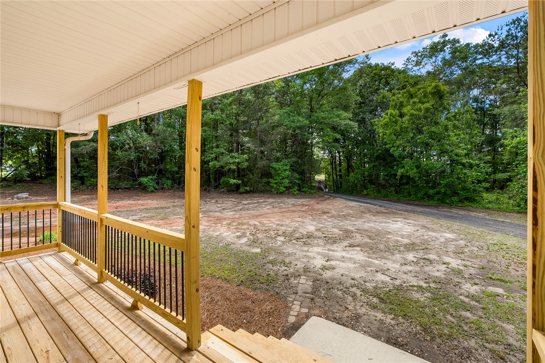 131 Lockaby Road Pelzer, SC 29669 - Photo 11 of 50 This inviting porch offers a tranquil retreat amidst a natural, verdant landscape.