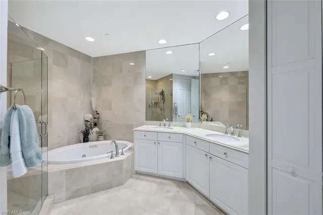 a bathroom with a bathtub a sink a toilet a mirror a vanity and shower
