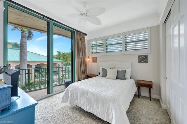 a bedroom with a large bed and a large window