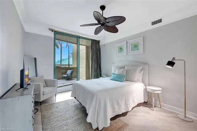 a bedroom with a large bed and a large window