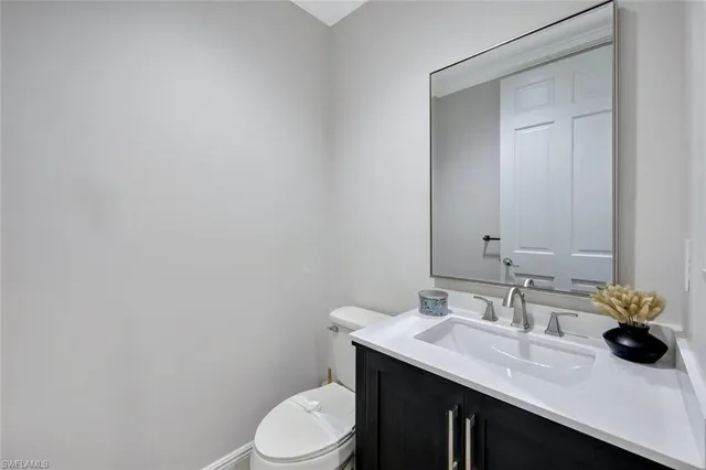 a bathroom with a sink a toilet and mirror