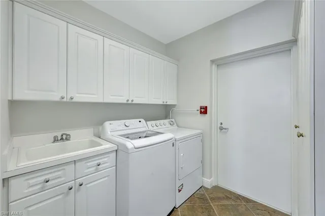 a utility room with sink dryer and washer