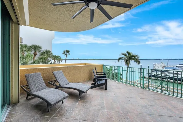 a roof deck with a couple of chairs