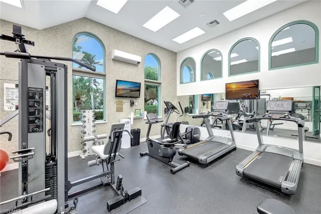 a room with gym equipment and a large mirror