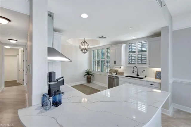 a living room with furniture large window and wooden floor