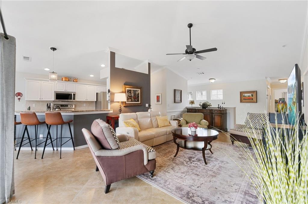 359 Dover Place, Unit E204 Naples, FL 34104 - Photo 11 of 49 a living room with furniture a rug and white walls