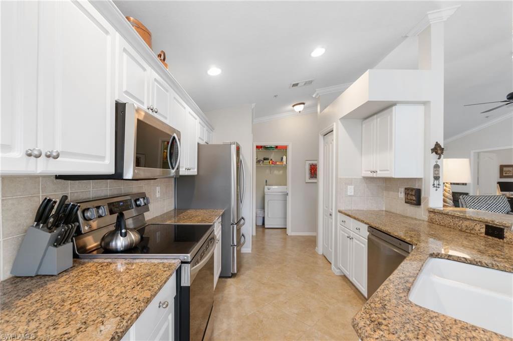 359 Dover Place, Unit E204 Naples, FL 34104 - Photo 15 of 49 a kitchen with stainless steel appliances granite countertop a sink stove and refrigerator