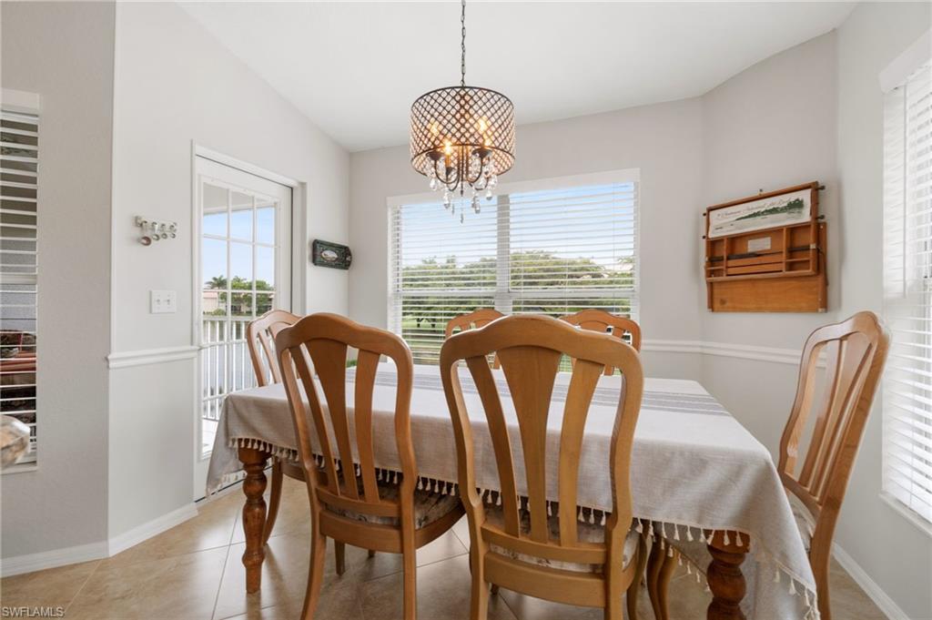 359 Dover Place, Unit E204 Naples, FL 34104 - Photo 20 of 49 a view of a dining room with furniture window and wooden floor