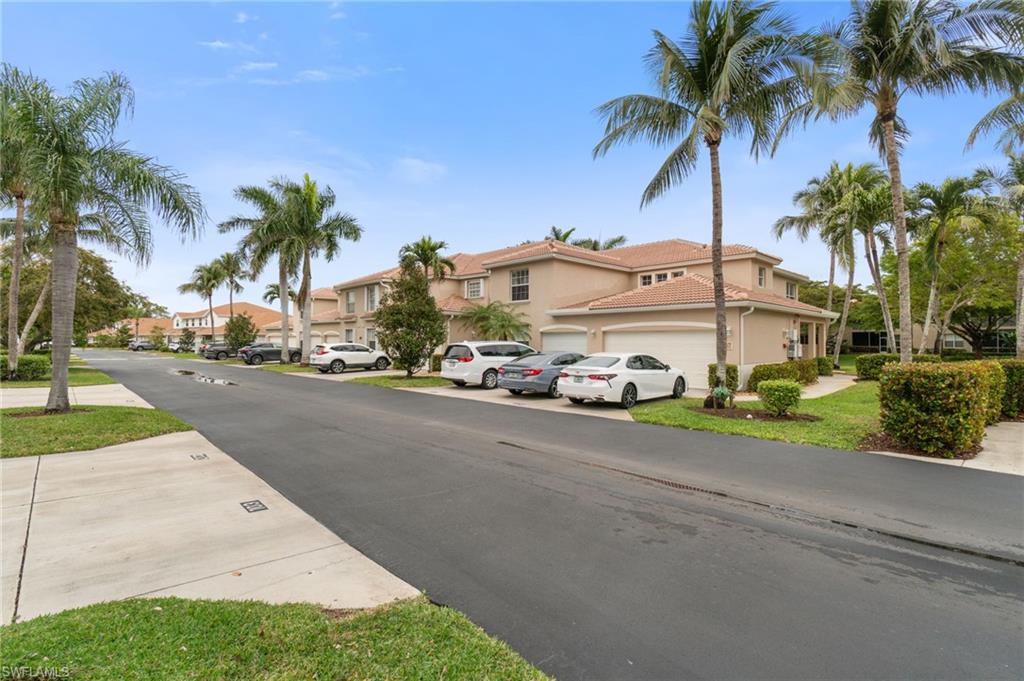 359 Dover Place, Unit E204 Naples, FL 34104 - Photo 2 of 49 a front view of multiple houses with palm trees