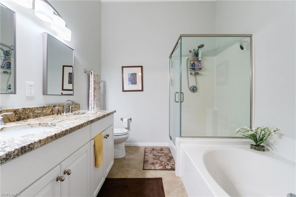 359 Dover Place, Unit E204 Naples, FL 34104 - Photo 23 of 49 a bathroom with a granite countertop sink a toilet and shower