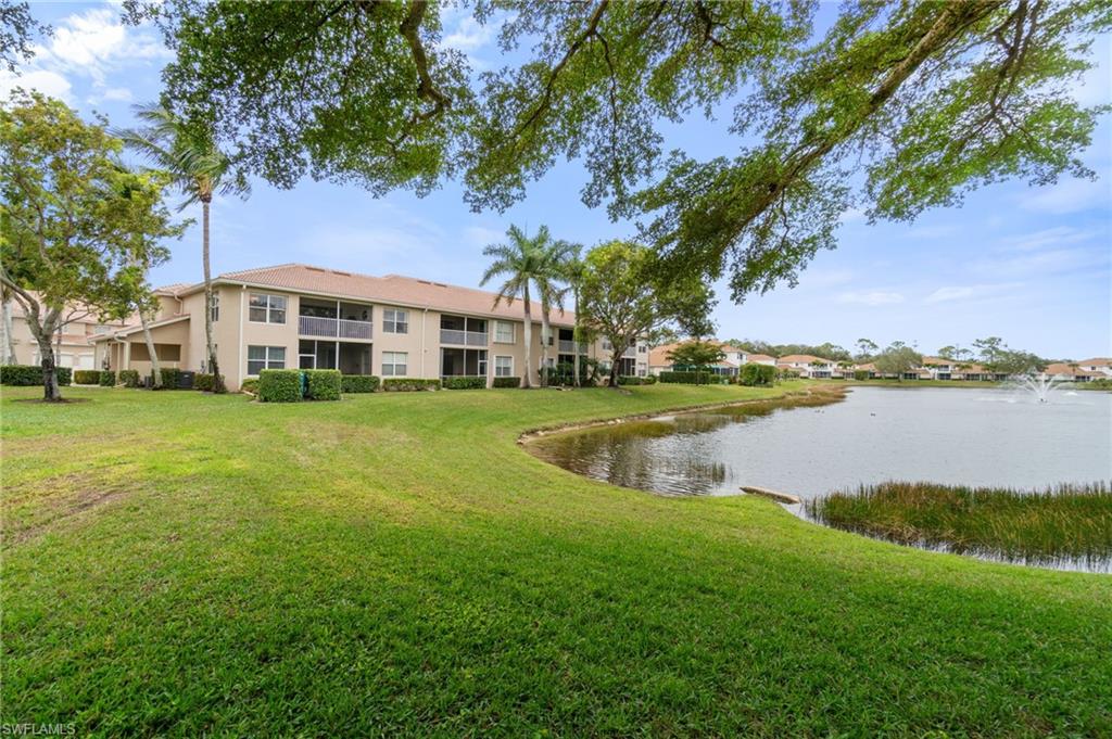 359 Dover Place, Unit E204 Naples, FL 34104 - Photo 39 of 49 a view of a house with a yard and sitting area