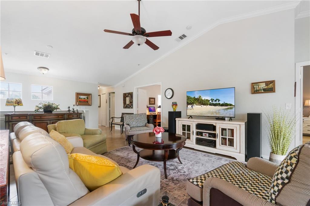 359 Dover Place, Unit E204 Naples, FL 34104 - Photo 5 of 49 a living room with furniture a flat screen tv and a dining table