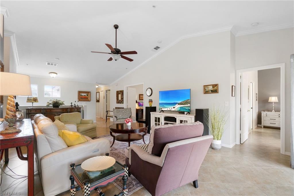 359 Dover Place, Unit E204 Naples, FL 34104 - Photo 6 of 49 a living room with furniture a ceiling fan and a rug
