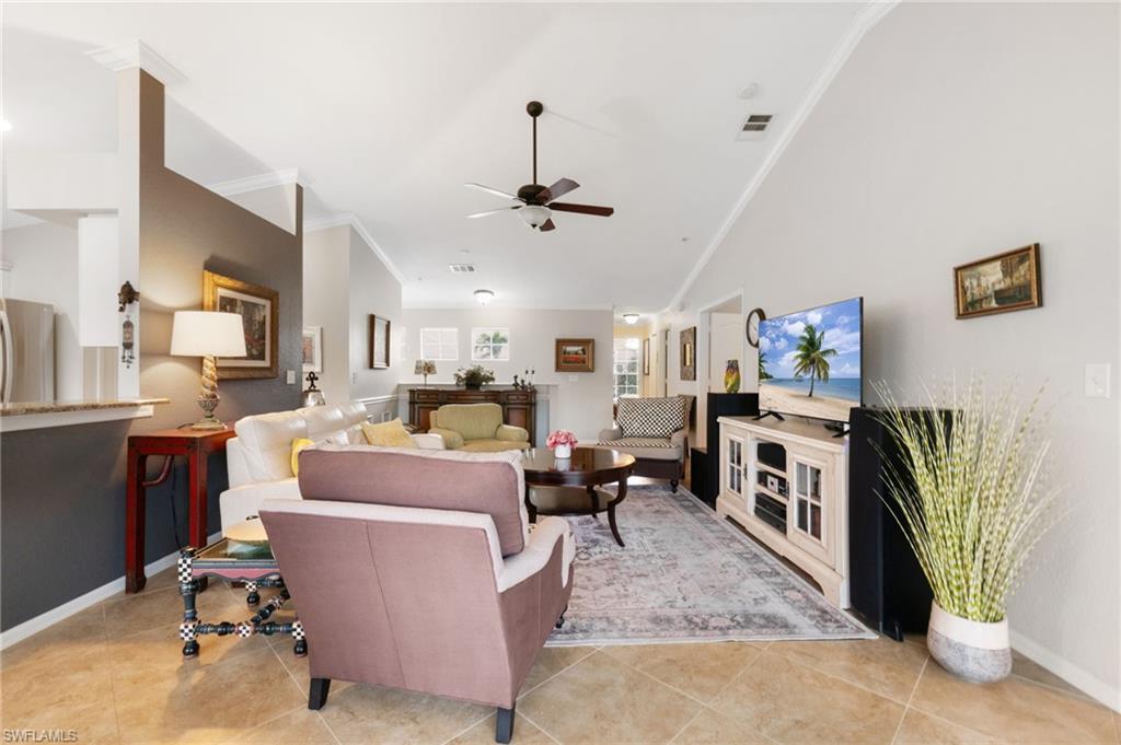 359 Dover Place, Unit E204 Naples, FL 34104 - Photo 7 of 49 a living room with furniture a fireplace and a chandelier