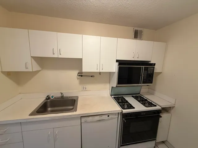 a kitchen with a stove and a microwave