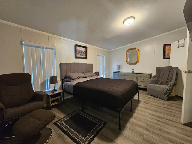 a bedroom with a bed couch and window