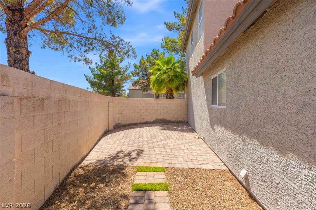 2377 Ramsgate Drive Henderson, NV 89074 - Photo 23 of 25 A private outdoor space with paver stone patio and drought-resistant landscaping awaits.