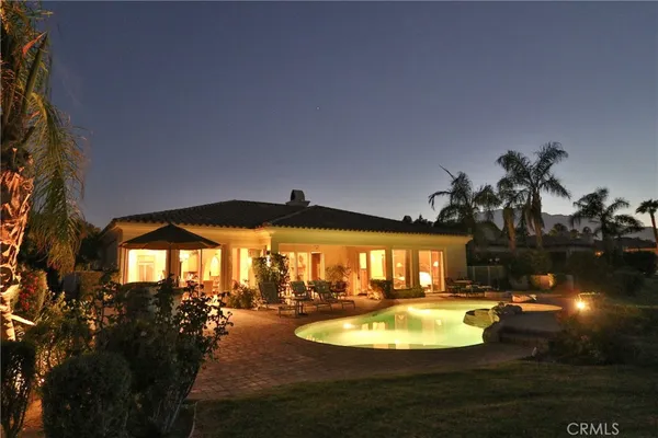 a view of a swimming pool with an outdoor space and seating area